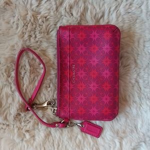 Coach pink logo print wristlet.